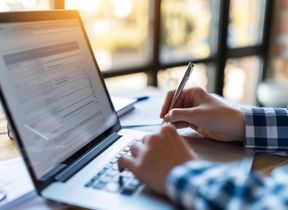 person-using-laptop-at-a-desk